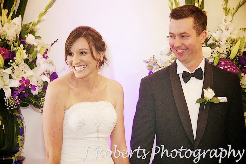 bride and groom laughing with guests during ceremony - wedding ceremony sydney